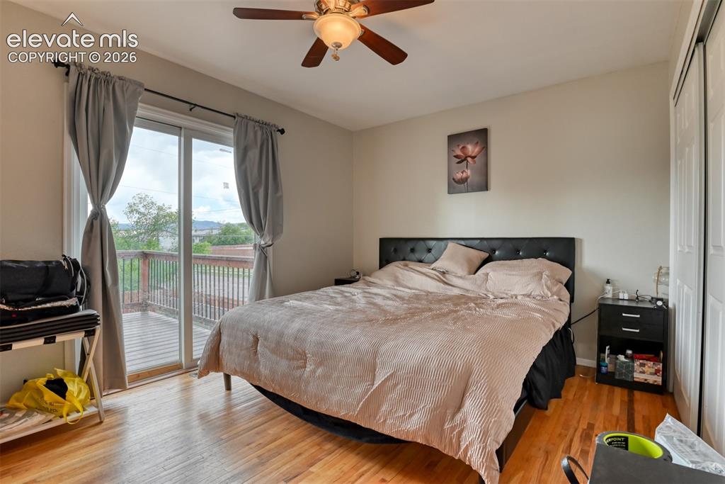 Image 14 of 46: Hardwood flooring and sliding glass door leading to an outdoor deck