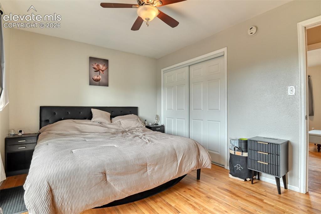 Image 15 of 46: Bedroom featuring wood-finish flooring, a ceiling fan with integrated light