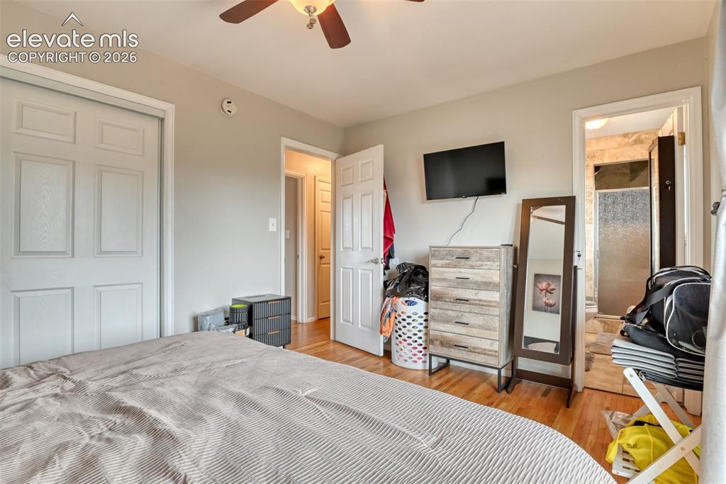 Image 16 of 46: Light-toned walls with wood-finish flooring, a ceiling fan with integrated 