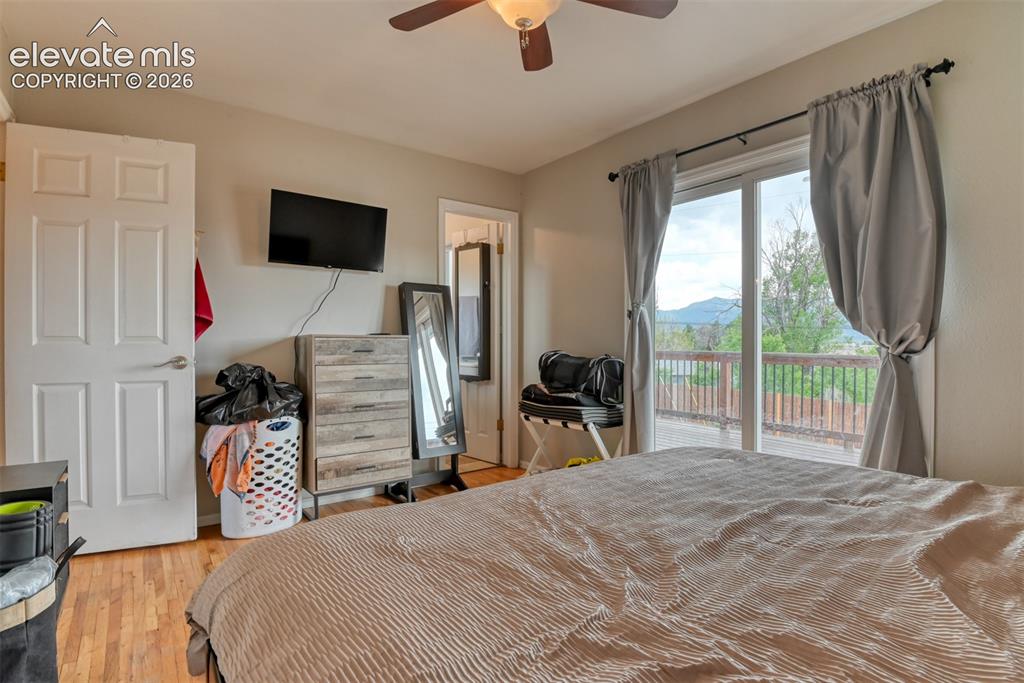 Image 17 of 46: Bedroom featuring wood-finish flooring, a ceiling fan with integrated light