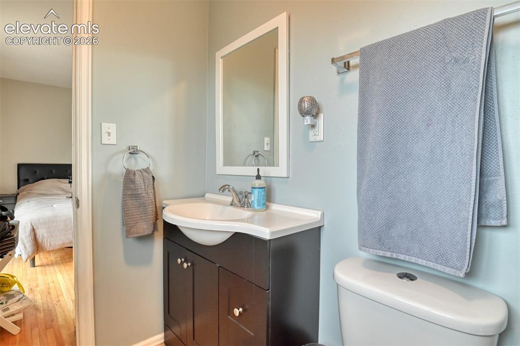 Image 19 of 46: Bathroom featuring a dark wood-finish vanity with a white countertop and in