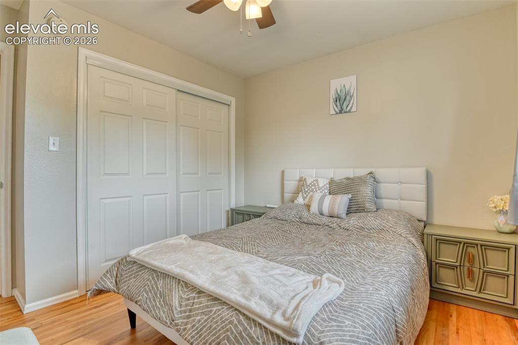 Image 20 of 46: Bedroom featuring wood-finish flooring, a ceiling fan with integrated light