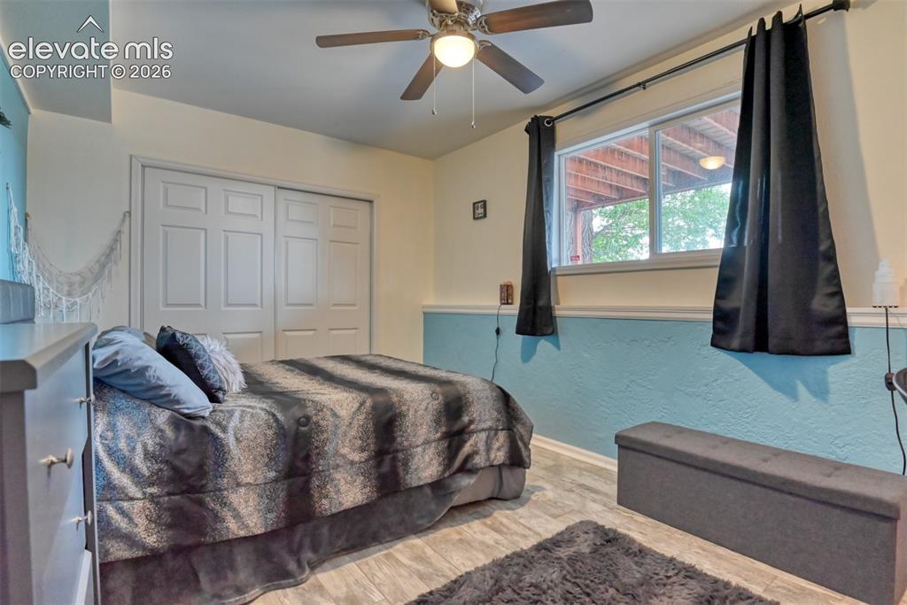 Image 31 of 46: Room featuring wood-finish flooring, a ceiling fan with integrated lighting