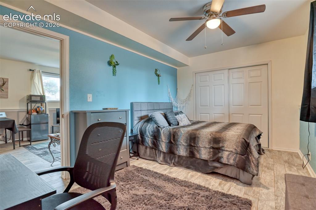 Image 32 of 46: Room featuring wood-finish flooring, a ceiling fan with integrated lighting