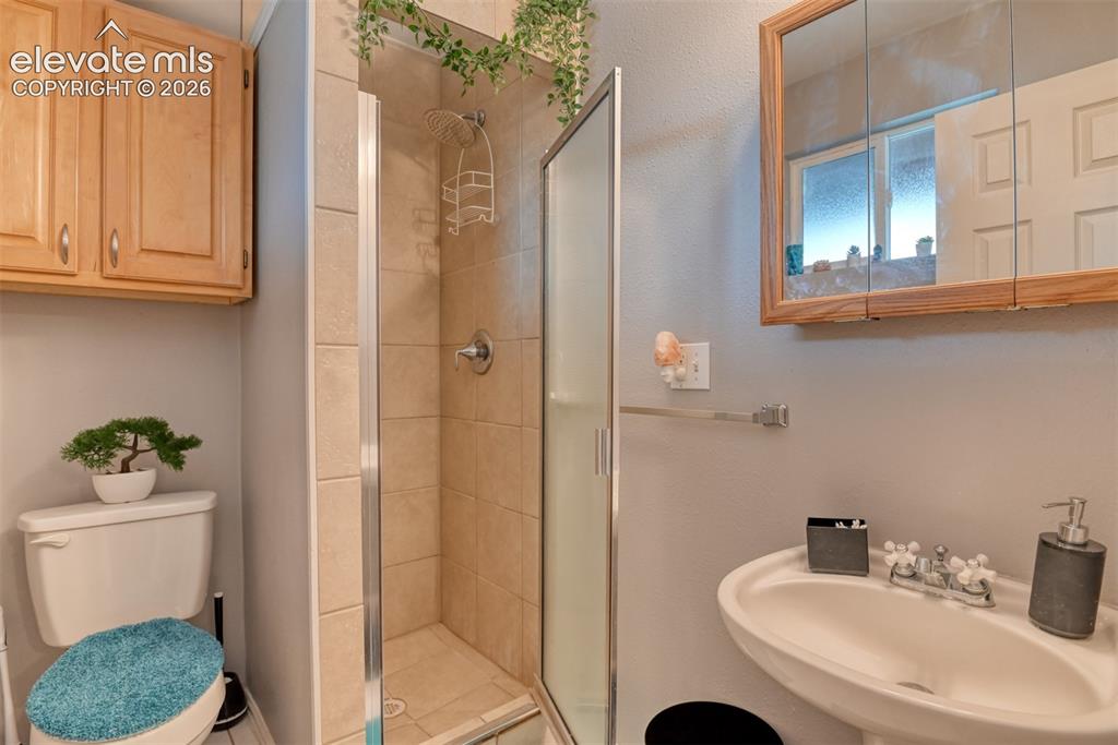 Image 33 of 46: Three-quarter bathroom featuring a standalone shower with glass enclosure, 