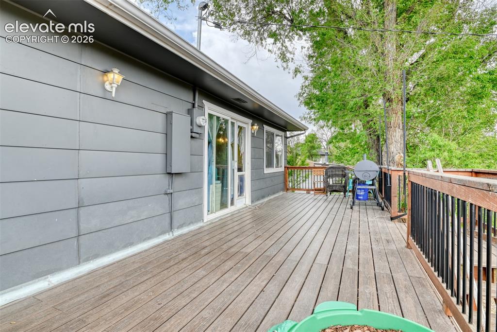 Image 39 of 46: Expansive outdoor deck featuring wood flooring and railings with black spin