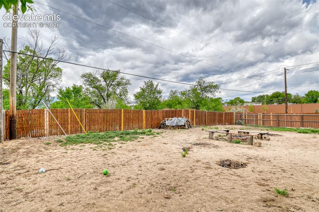 Image 44 of 46: Fenced backyard with wood fencing