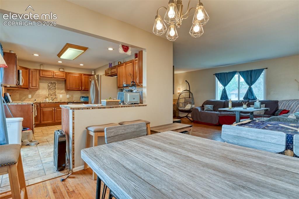 Image 8 of 46: Kitchen area featuring wood-finish cabinetry, stainless steel appliances, t