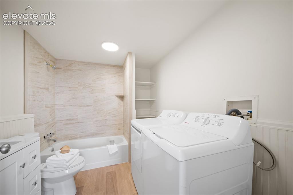 Image 13 of 18: Updated bathroom with laundry area