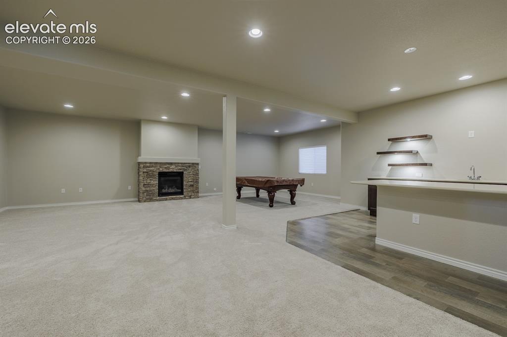 Image 31 of 47: large family room with wet bar