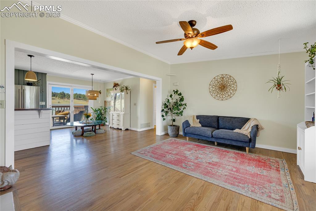 Image 13 of 42: This inviting living space features hardwood floors, a fireplace, a ceiling