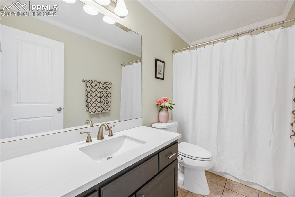 Image 16 of 42: Bathroom featuring a vanity with a white marble countertop