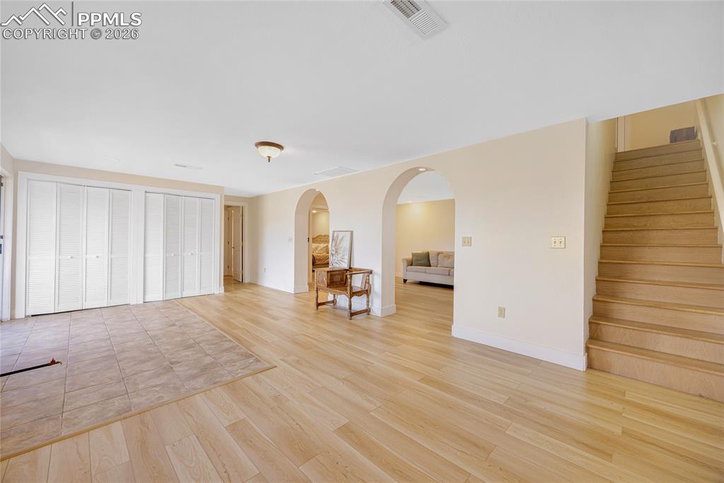 Image 26 of 42: The property features a foyer with hardwood flooring and feature wall