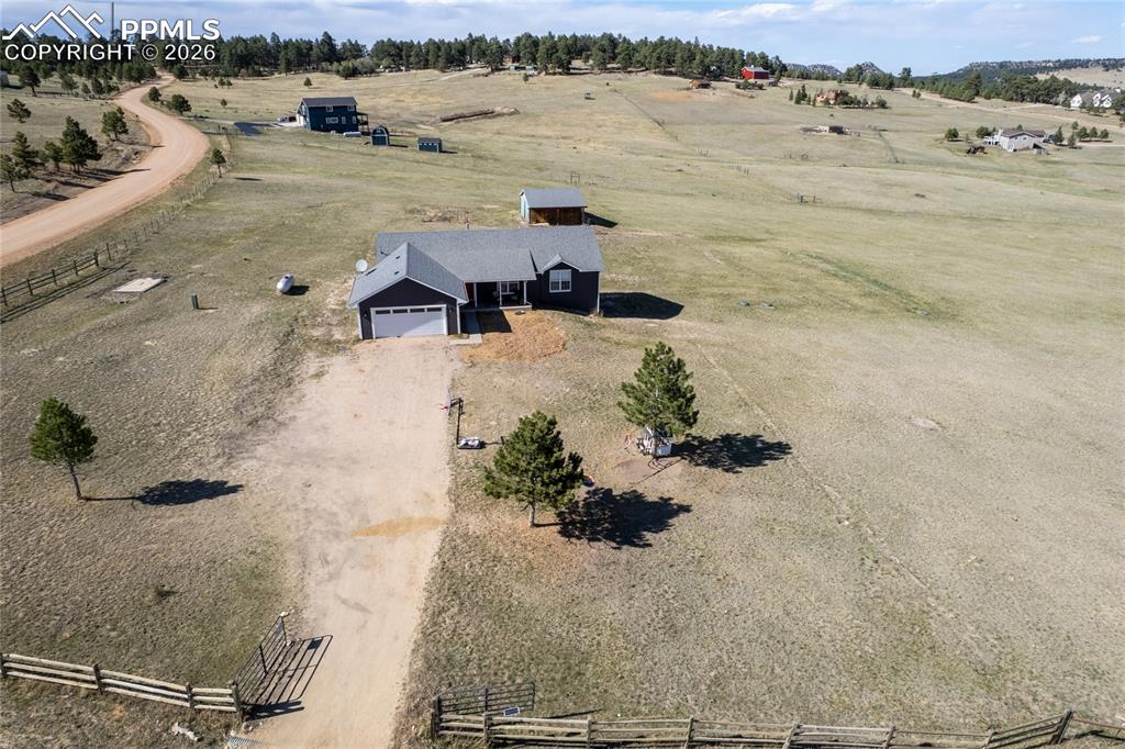Image 36 of 42: The property features a ranch-style home with a dark exterior and an attach
