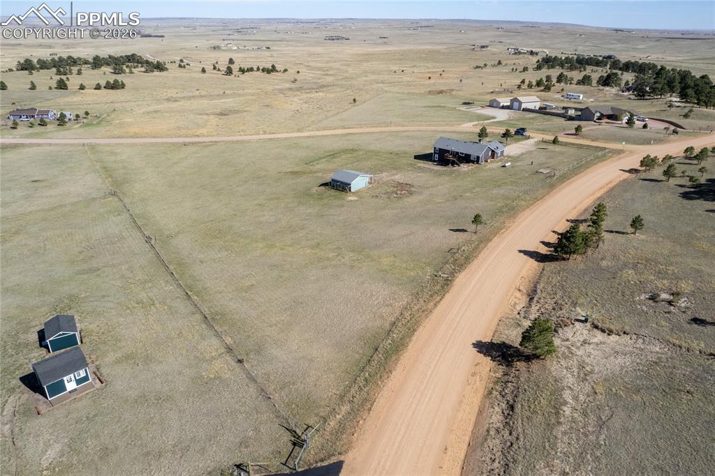 Image 38 of 42: Aerial view of the property showing a large expanse of land, a main residen