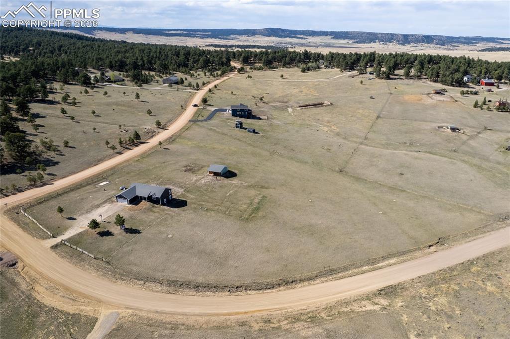 Image 39 of 42: This property features an expansive lot with a main residence, a detached s