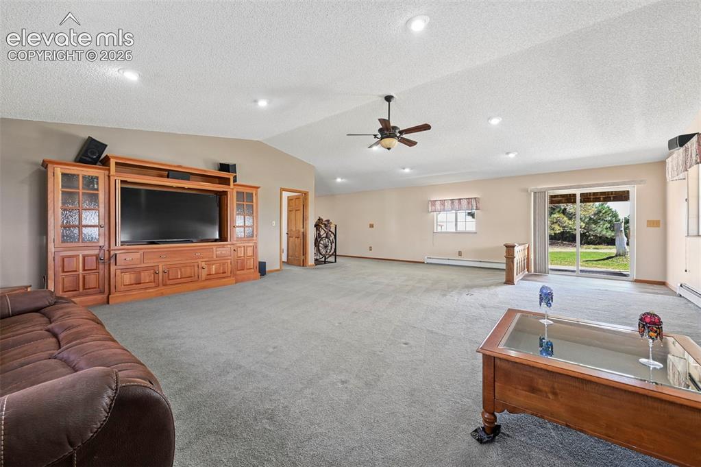 Image 5 of 50: Grand Room with recessed lighting and Sliding Door to covered concrete porc