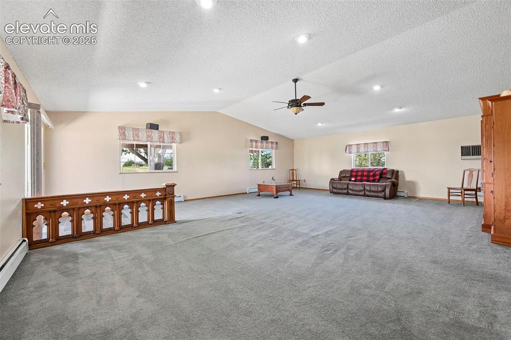 Image 6 of 50: Grand Room offers ceiling fan and Entertainment Center 