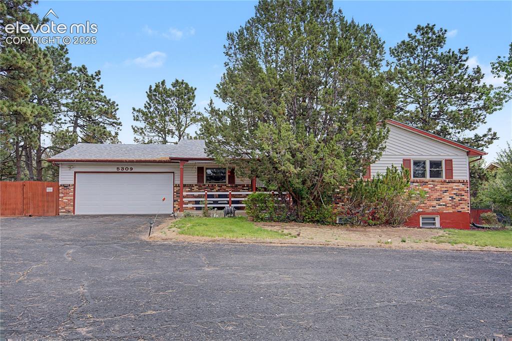 Image 1 of 38: Ranch-style residence featuring a combination of horizontal siding and bric