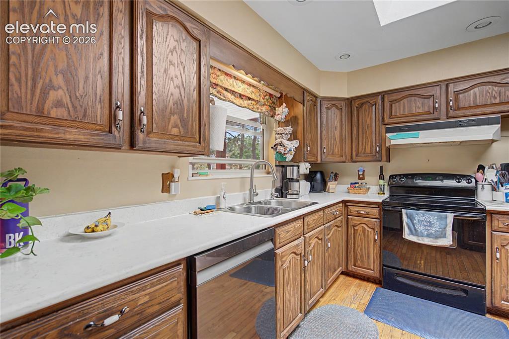 Image 13 of 38: Kitchen featuring wood-finish cabinetry, white countertops, a stainless ste