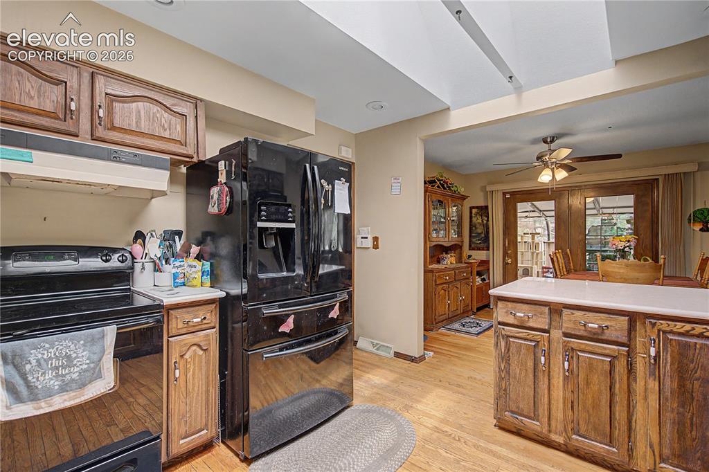 Image 14 of 38: Kitchen featuring wood-finish flooring and wood cabinetry