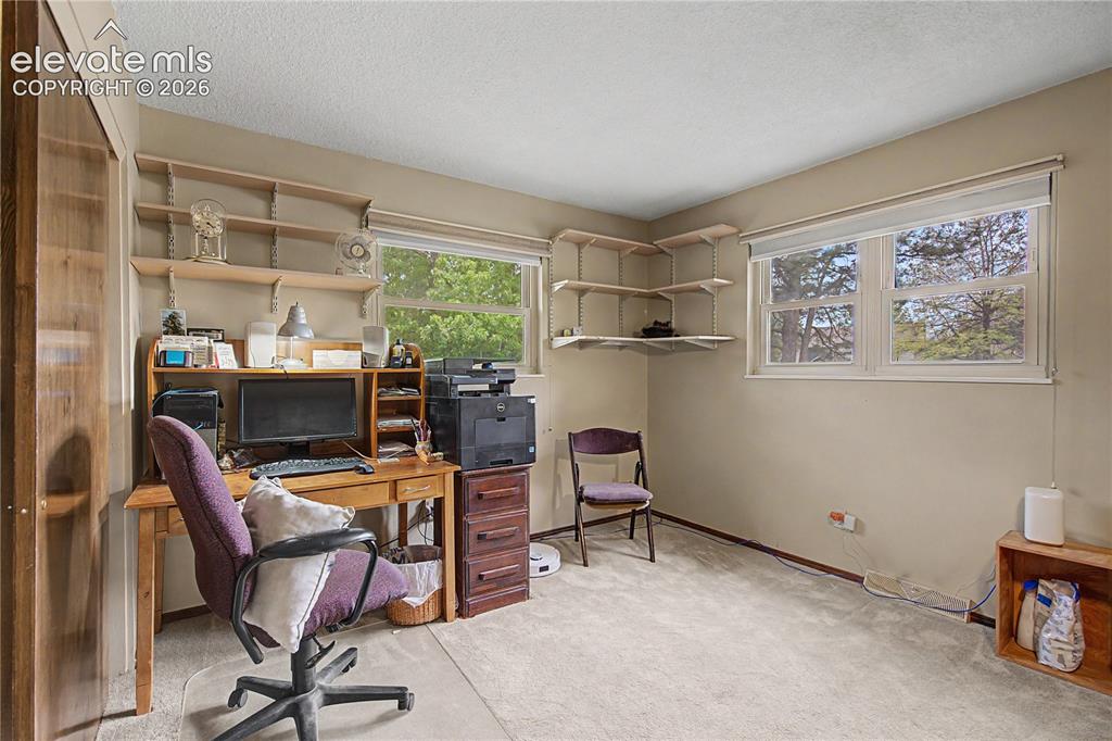 Image 19 of 38: Interior room featuring light-toned carpeting and neutral wall paint