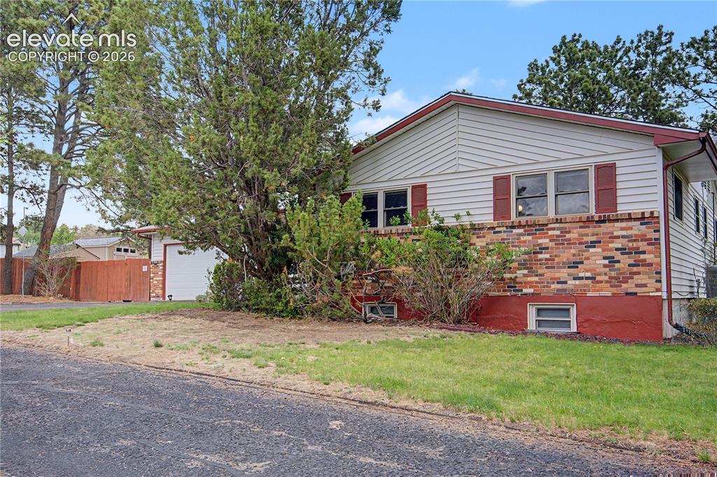 Image 2 of 38: Two-story exterior featuring multi-tone brick and horizontal siding