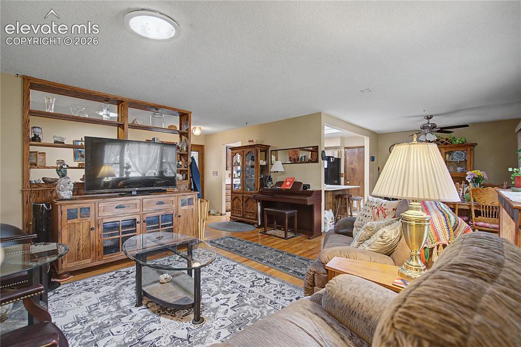 Image 6 of 38: Living area featuring a prominent wood-finish built-in entertainment center