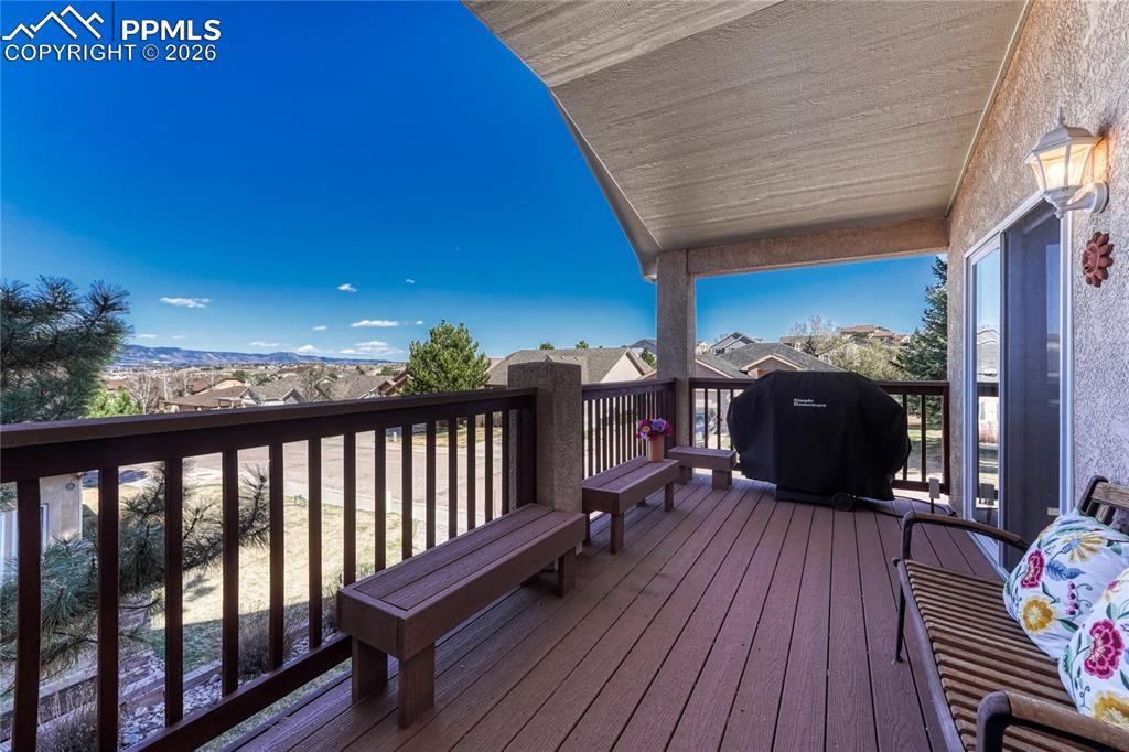 Image 19 of 50: Covered deck off the primary bedroom and great room.
