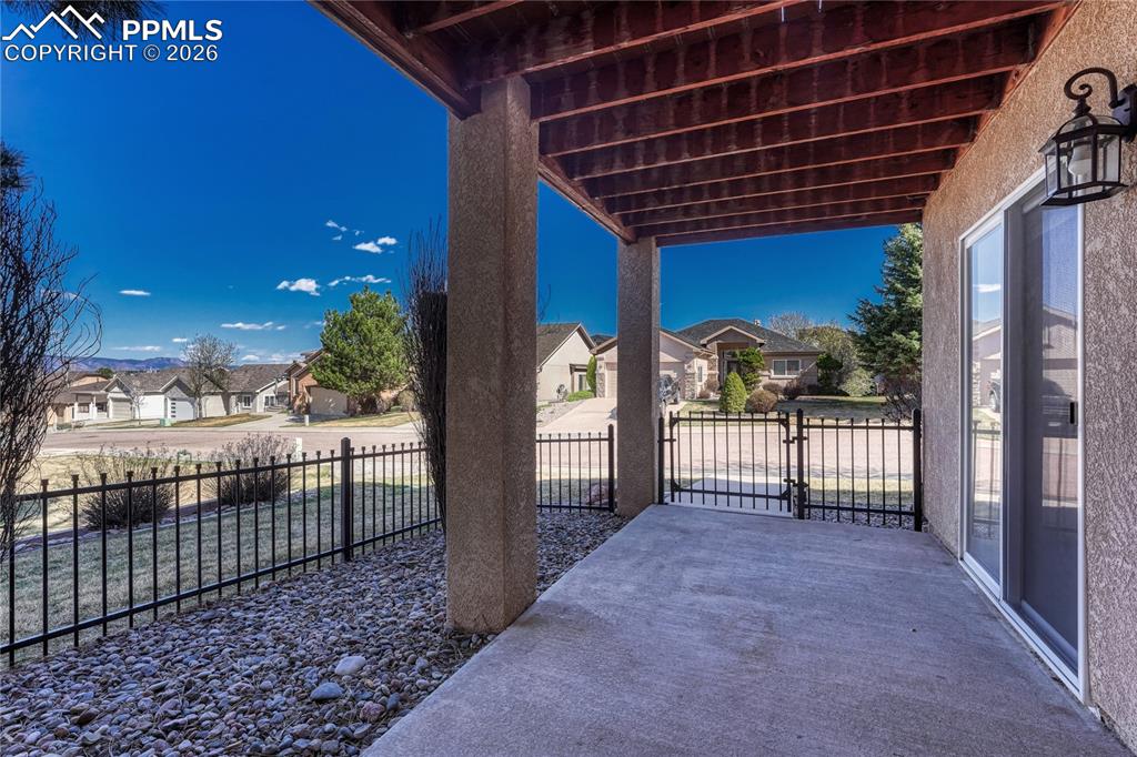 Image 32 of 50: ...leads out to this fenced-in patio...