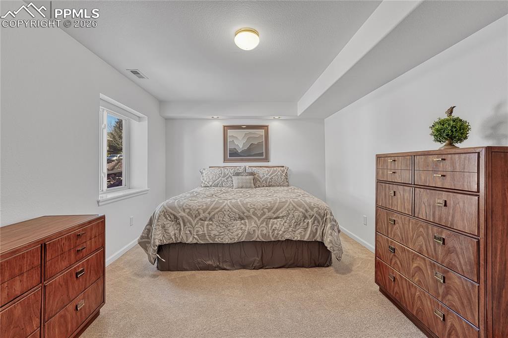 Image 44 of 50: First of two basement bedrooms...