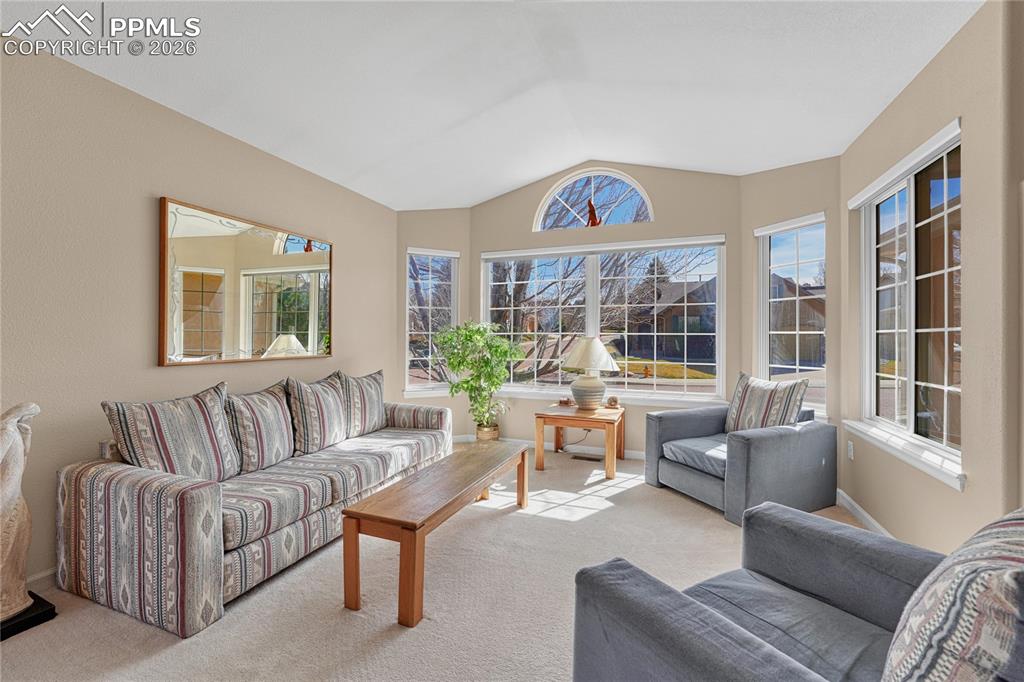 Image 5 of 50: Vaulted ceiling in this light and bright living room.