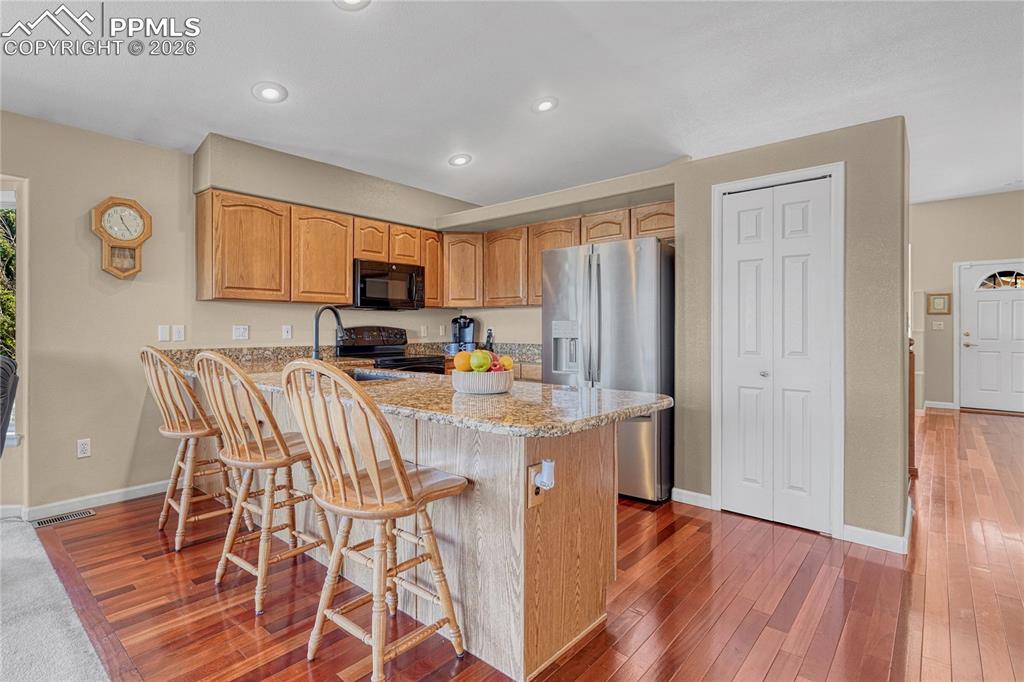 Image 8 of 50: Kitchen has Brazilian cherry hardwood floors, 2 pantry spaces...