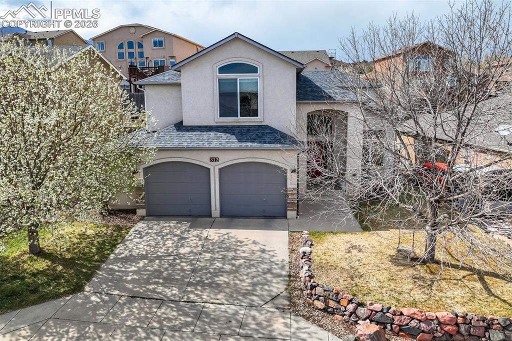 Caption: West side stunner with an oversized garage. 