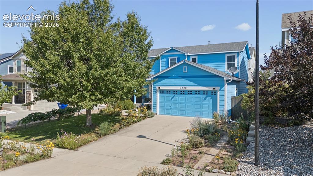 Image 1 of 35: Two-story residence with blue siding and a light gray shingle roof