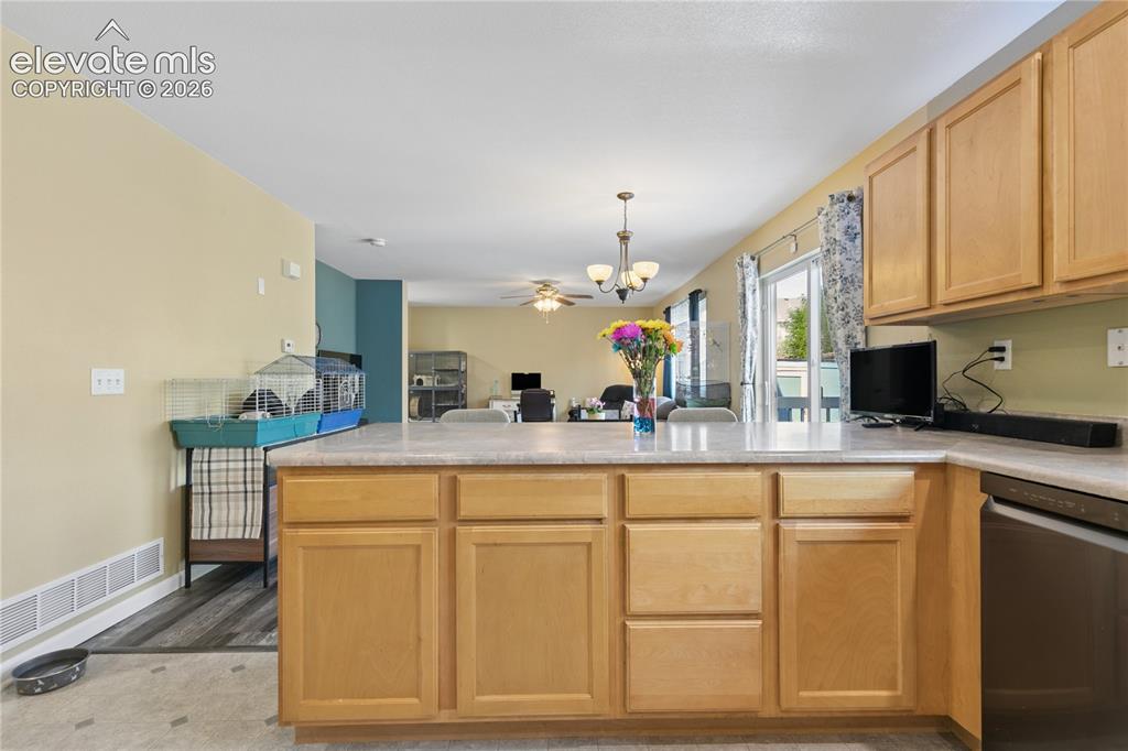Image 12 of 35: Kitchen island with light-toned cabinetry and light-colored countertops