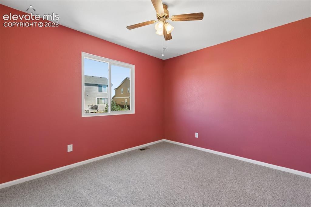 Image 18 of 35: Window-equipped room featuring a ceiling fan with integrated lighting, neut