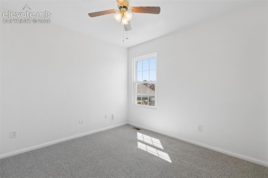 Image 19 of 35: Recessed window with white framing, light gray carpeting, and a ceiling fan