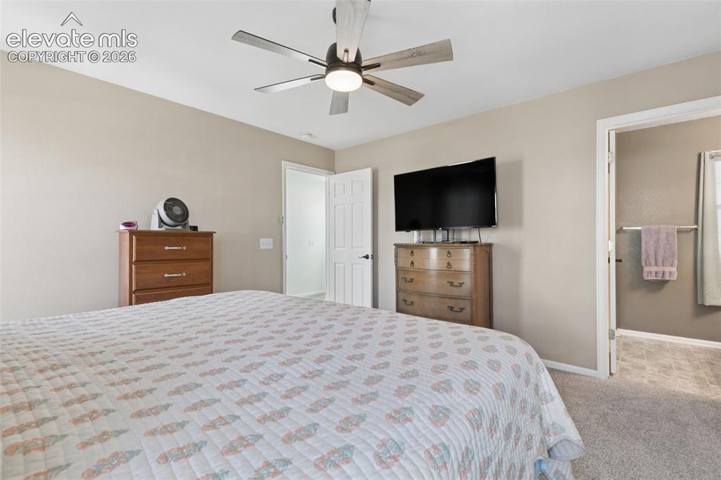 Image 20 of 35: Recessed lighting with a ceiling fan, neutral wall tones, textured carpetin