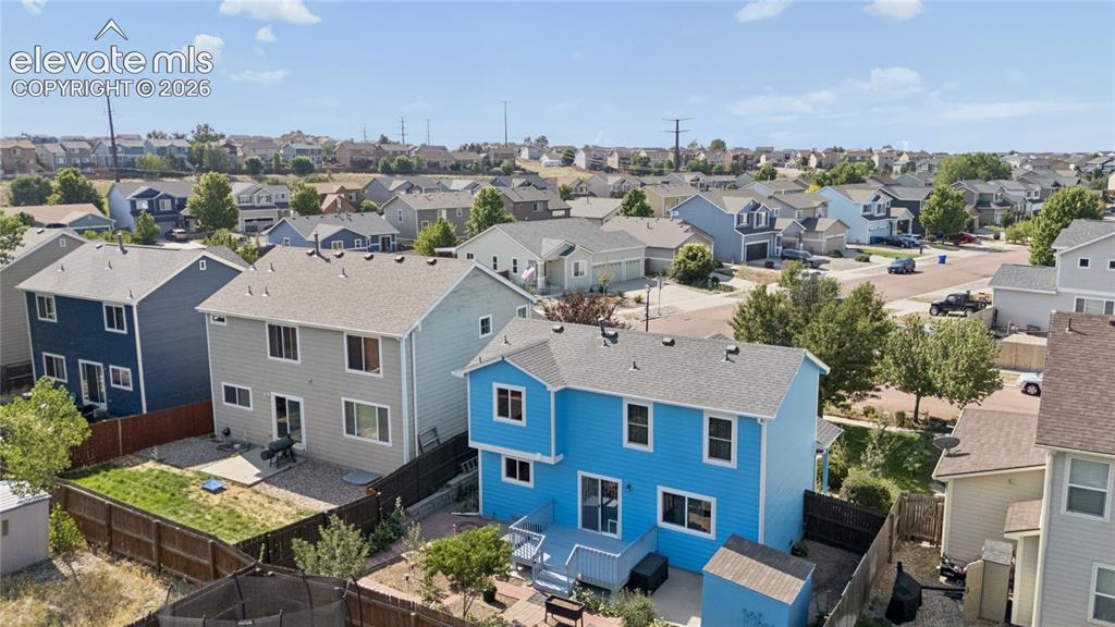 Image 34 of 35: Rear exterior featuring a blue siding finish, an elevated wood deck, a slid