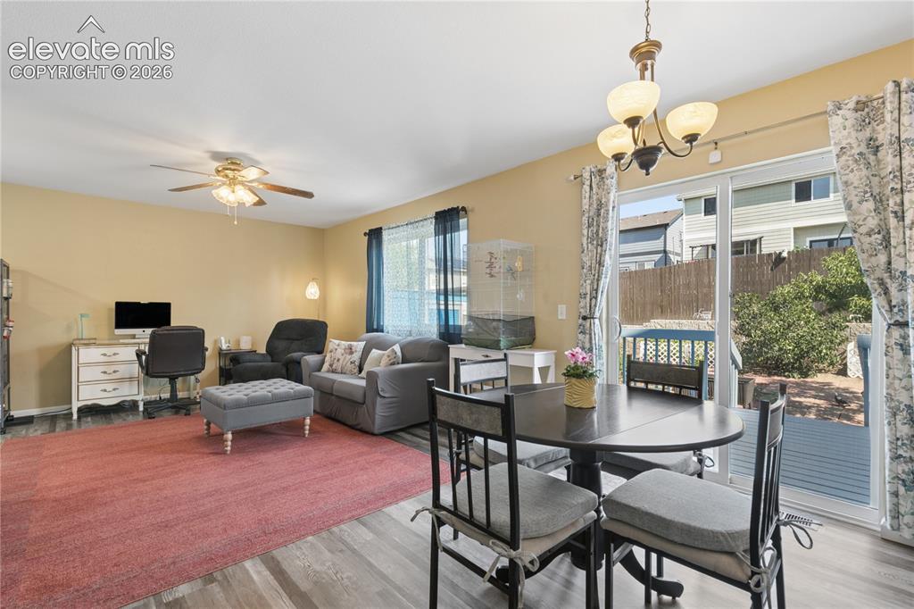 Image 7 of 35: Wood-finish flooring throughout, ceiling fan with integrated lighting, and