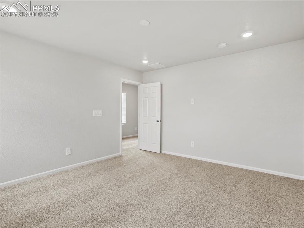 Image 12 of 22: Unfurnished room featuring recessed lighting and light carpet