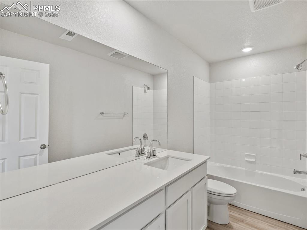 Image 16 of 22: Full bath featuring vanity, shower / washtub combination, and wood finished