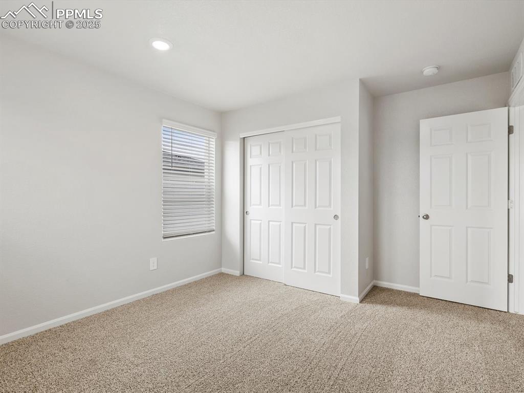 Image 17 of 22: Unfurnished bedroom featuring carpet flooring, a closet, and recessed light