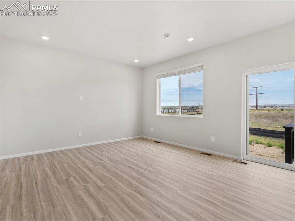 Image 6 of 22: Spare room with light wood-type flooring and recessed lighting