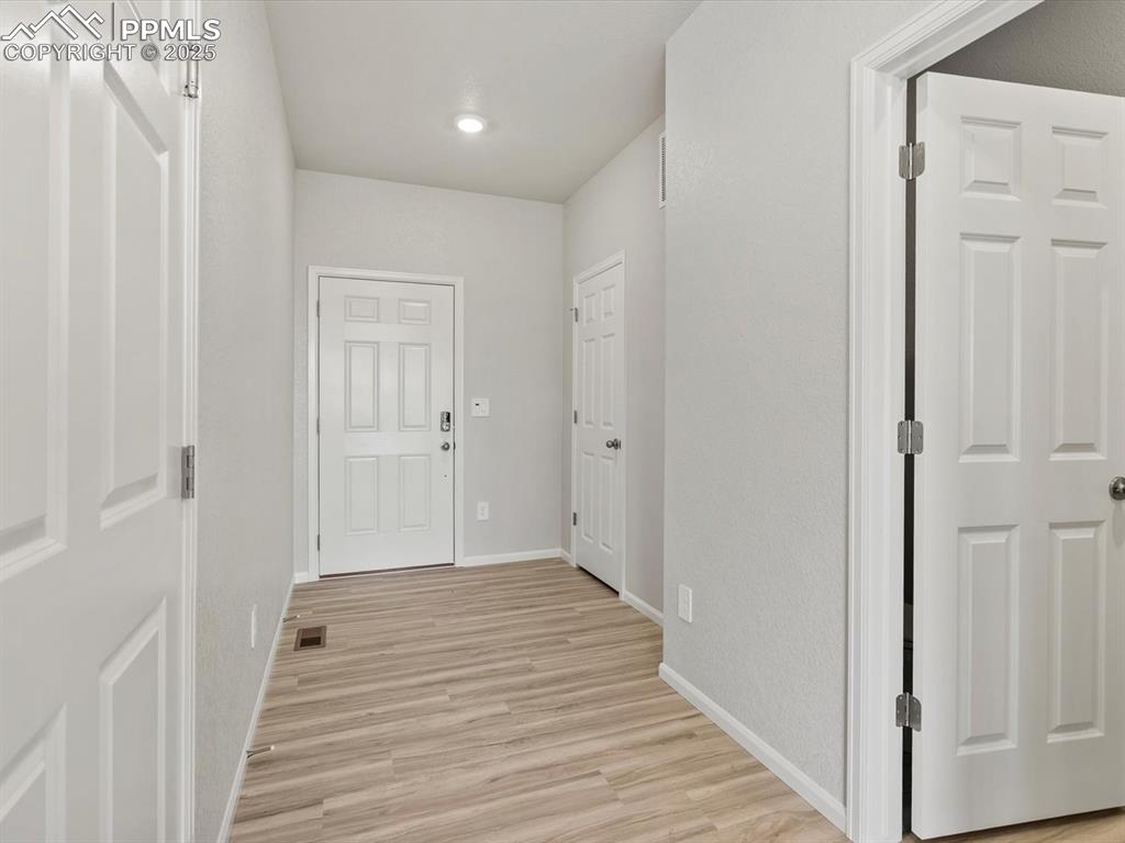 Image 7 of 22: Hall featuring light wood-type flooring and baseboards