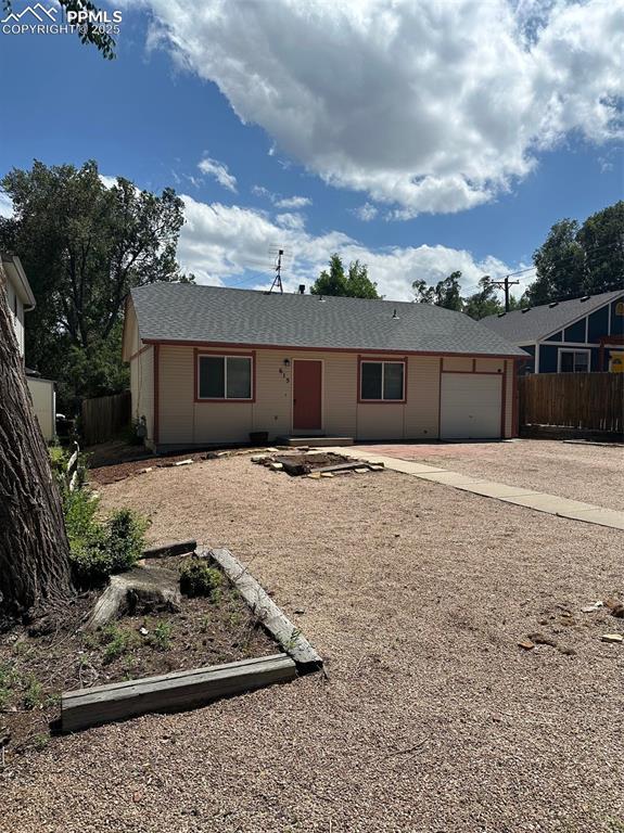 Caption: View of front of home featuring driveway and a garage