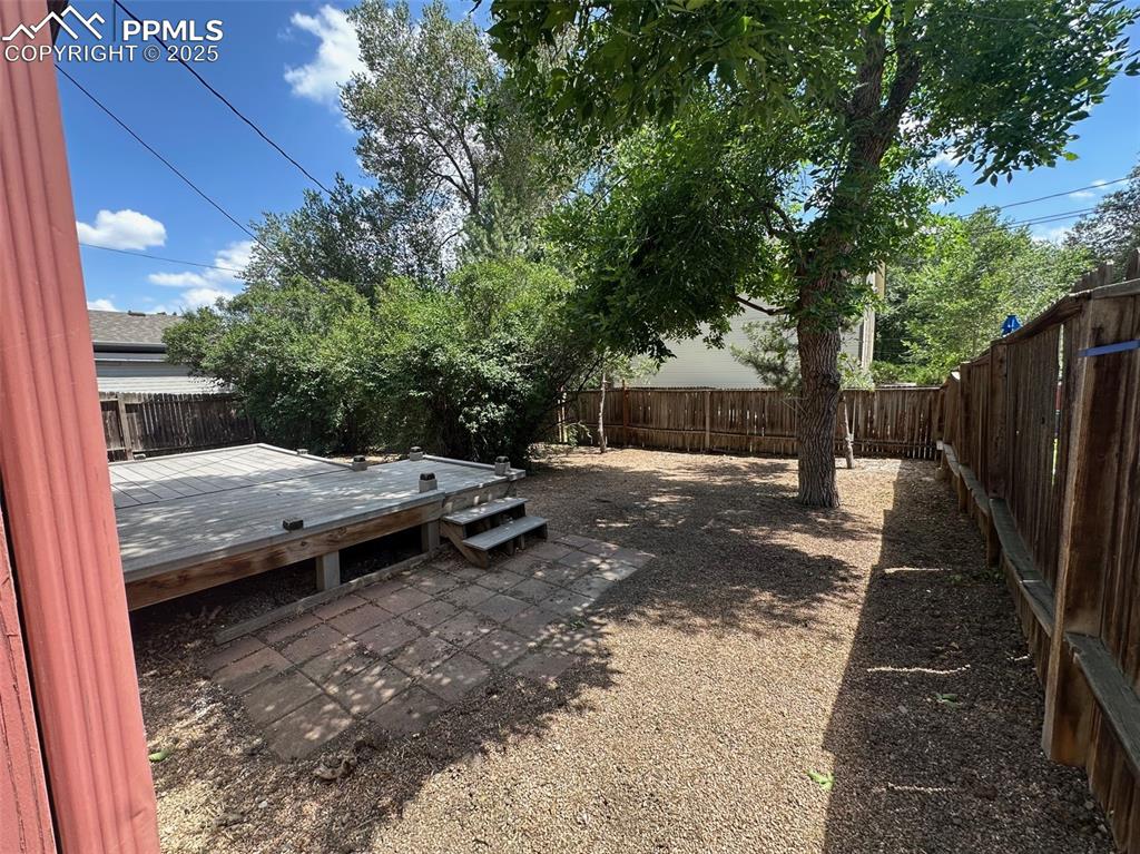 Image 19 of 22: Fenced backyard featuring a deck
