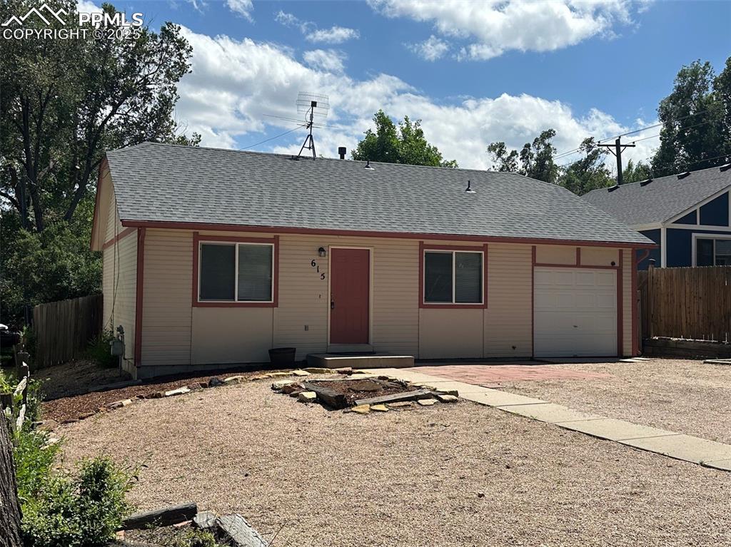 Image 2 of 22: Single story home with a shingled roof, driveway, and a garage