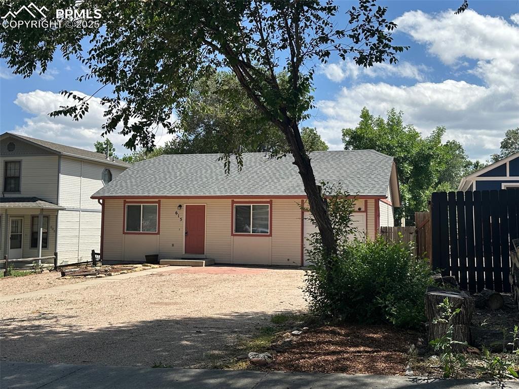 Image 3 of 22: View of front of property with roof with shingles, a garage, and driveway
